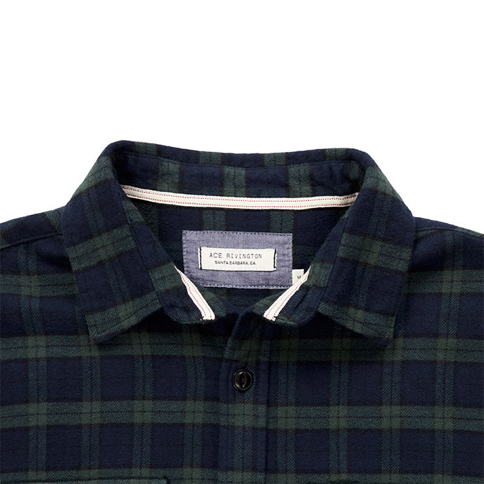 close up of collar and Ace Rivington logo tag on men's blue and green plaid pattern flannel