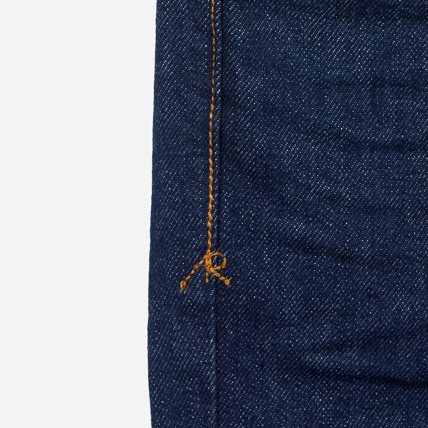 close up of stitching on pair of dark blue athletic taper jeans with no wear