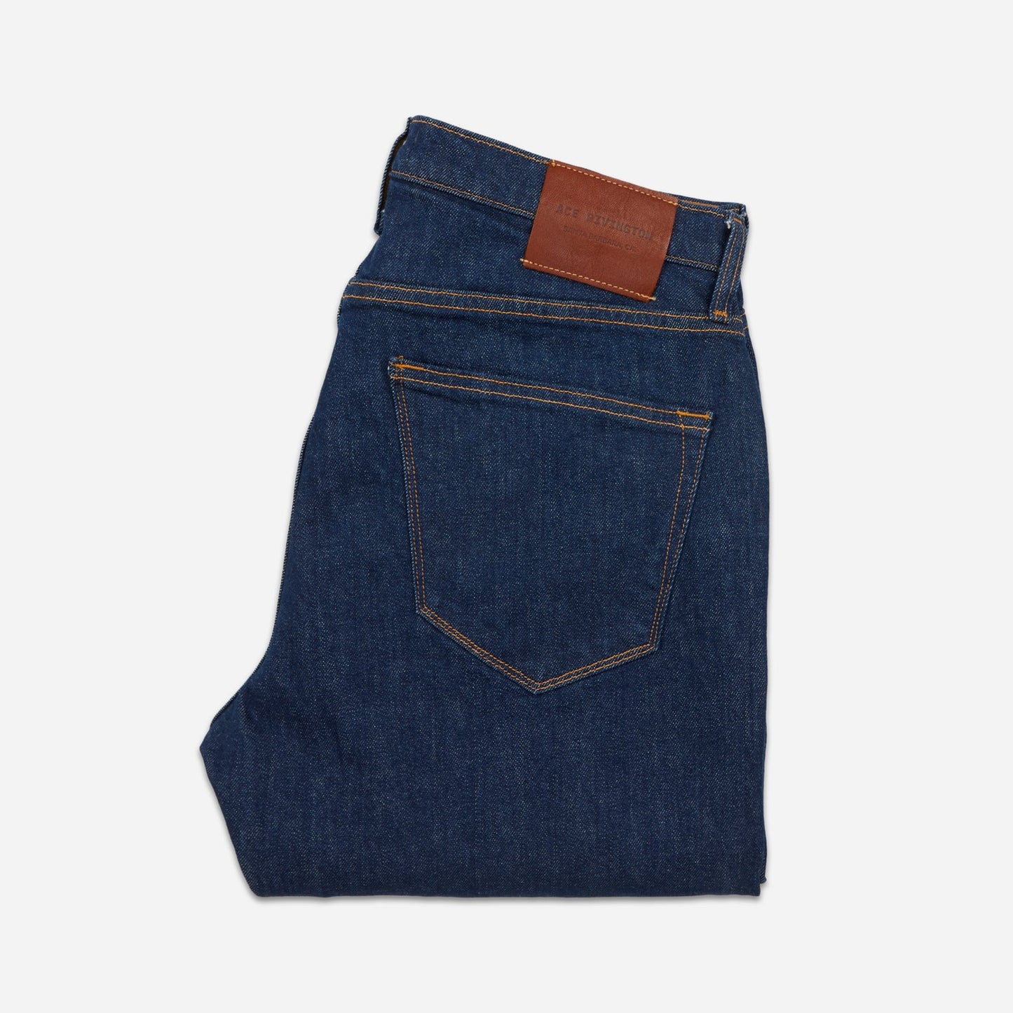 back of folded dark blue men's athletic taper jeans with no wear