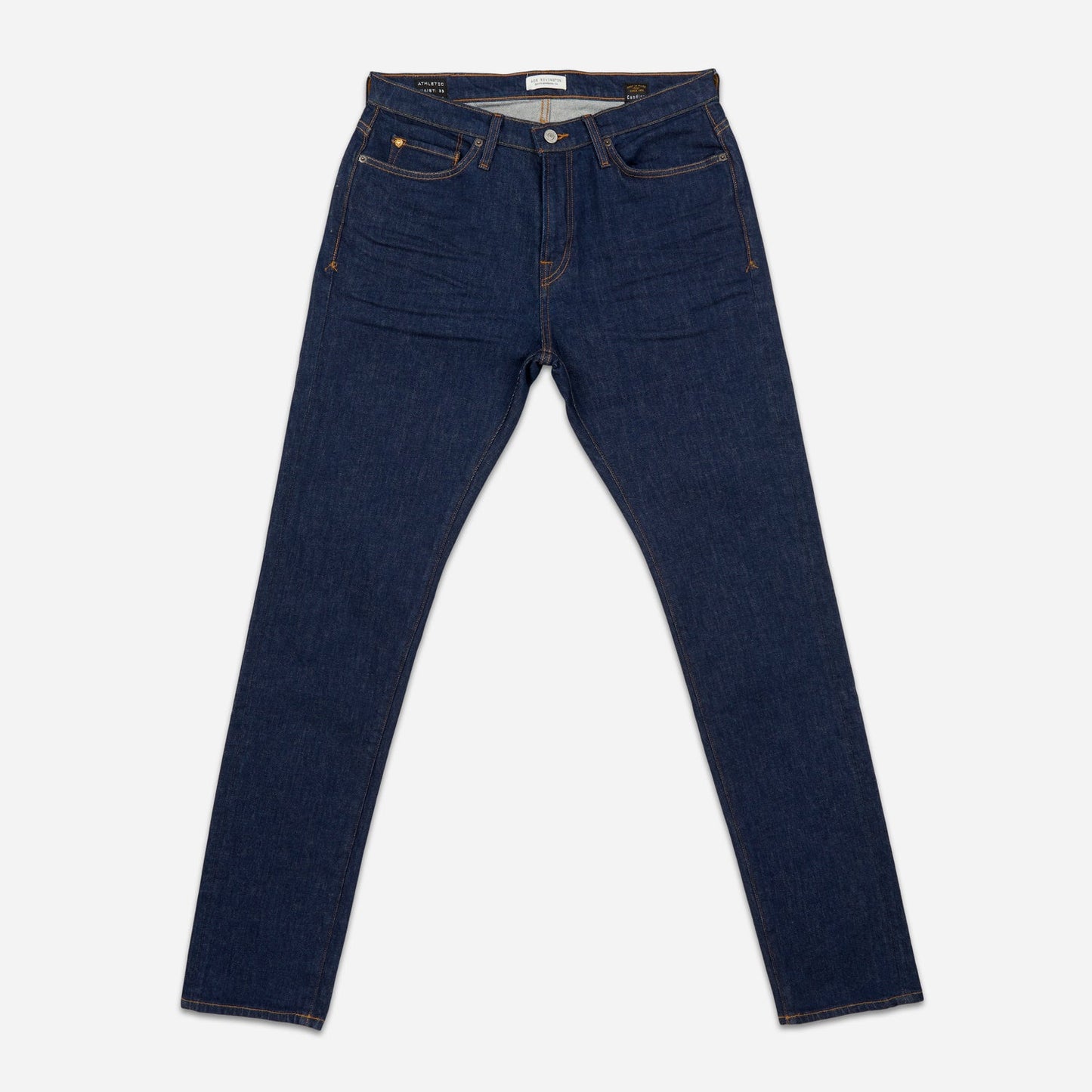front of pair of dark blue men's athletic taper jeans with no wear and legs fully extended