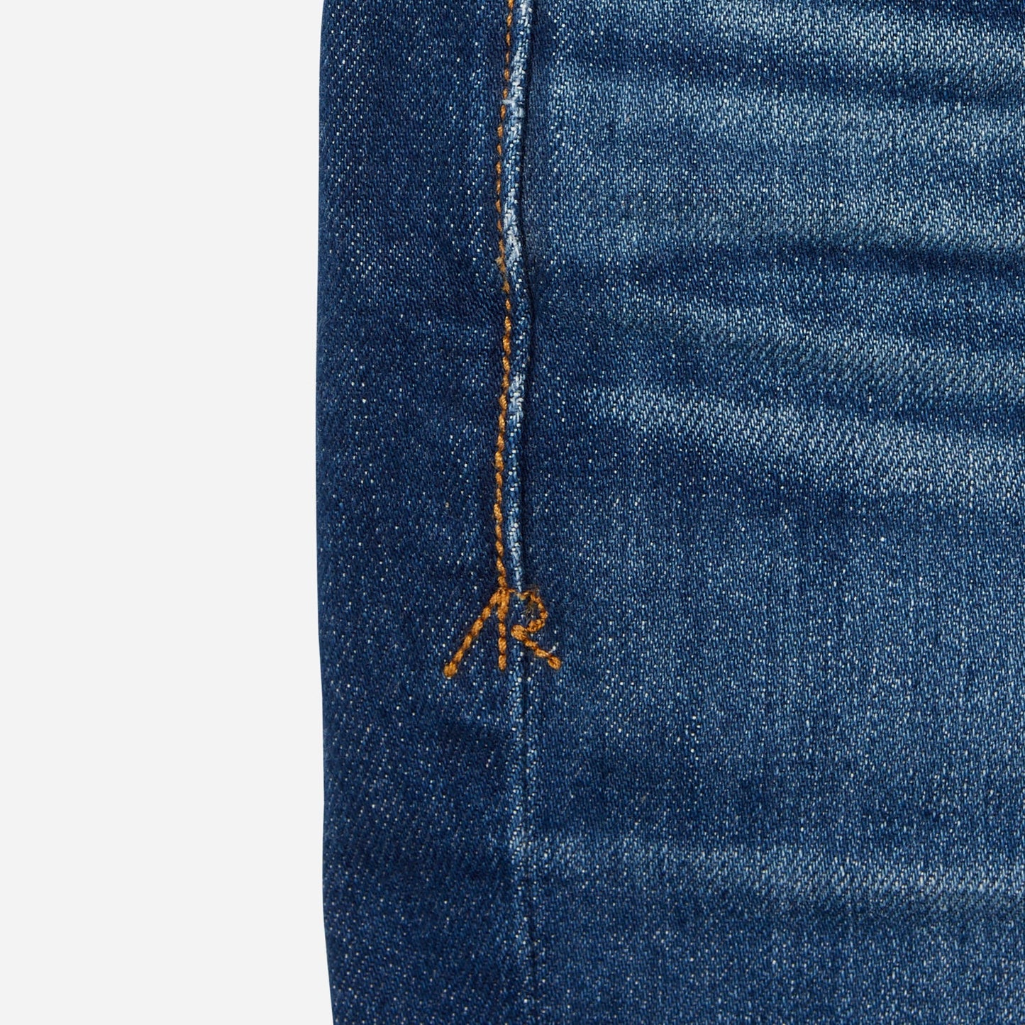 close up of stitching on dark blue vintage athletic taper jeans
