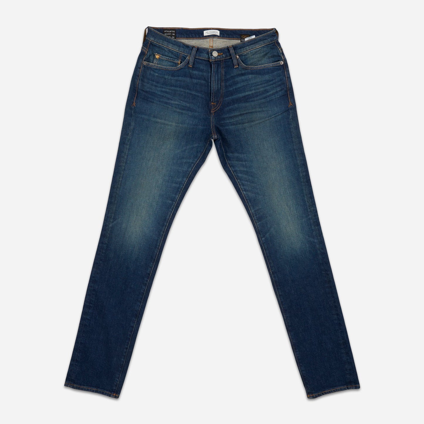 fully extended pair of men's athletic taper blue jeans with slight wear 