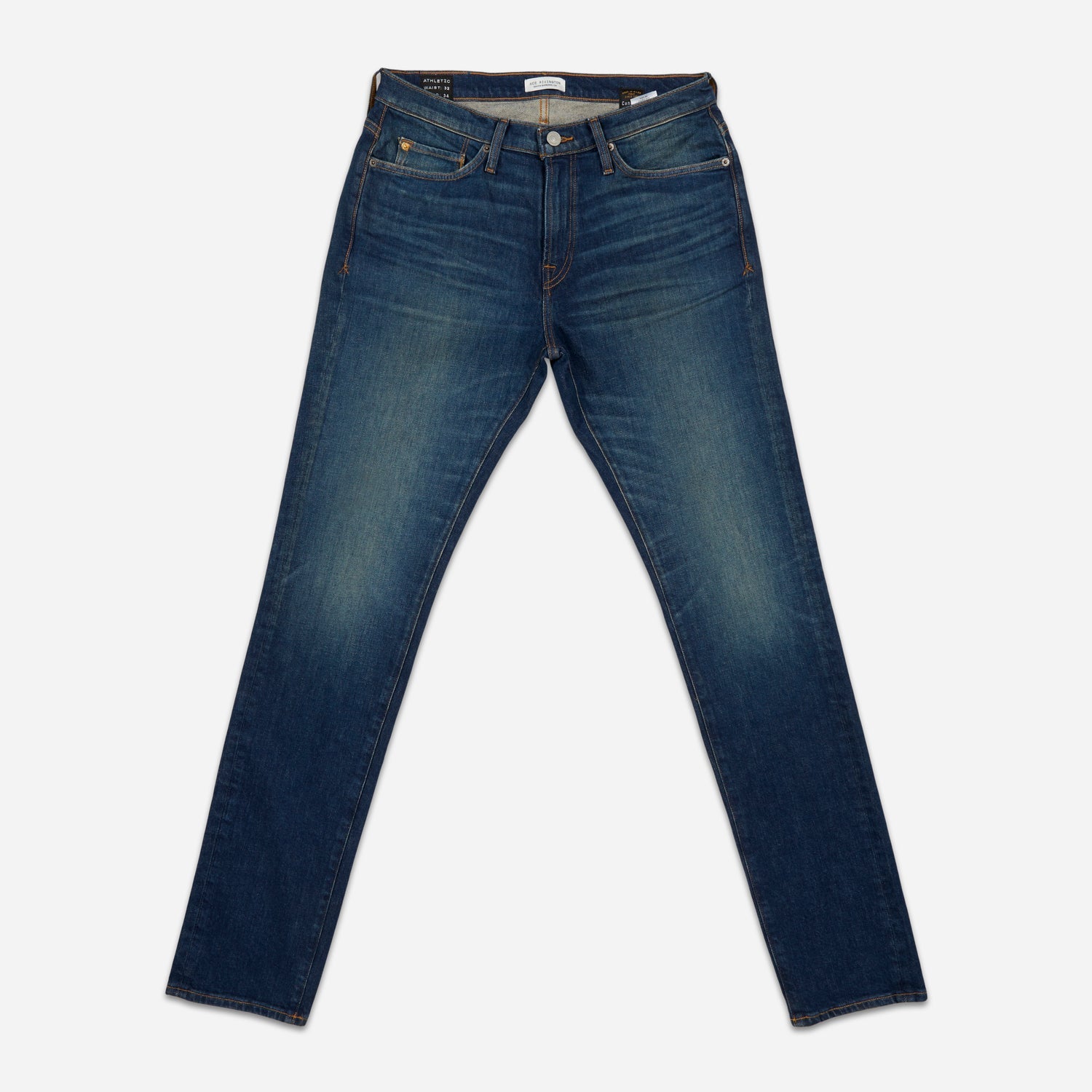 fully extended pair of men's athletic taper blue jeans with slight wear 