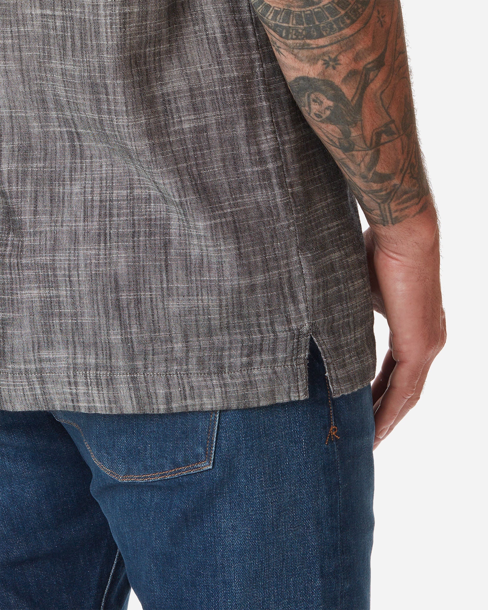 Back of model wearing Ace Rivington "Black" Double gauze soft-textured cotton fabric camp collar shirt with coconut buttons and left-breast pocket and a pair of Ace Rivington dark vintage blue denim jeans