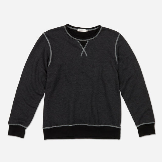 Fully extended frontal view of men's dark grey and black homespun french terry crew neck sweatshirt with white accent stitching