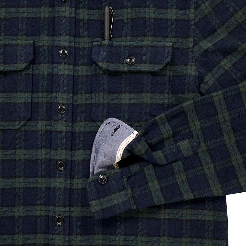 close up of pocket with pen and sleeve cuff of men's blue and green plaid pattern flannel 