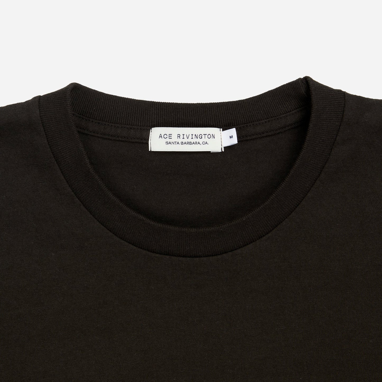 zoomed in view of plain black men's t shirt with Ace Rivington brand logo in medium