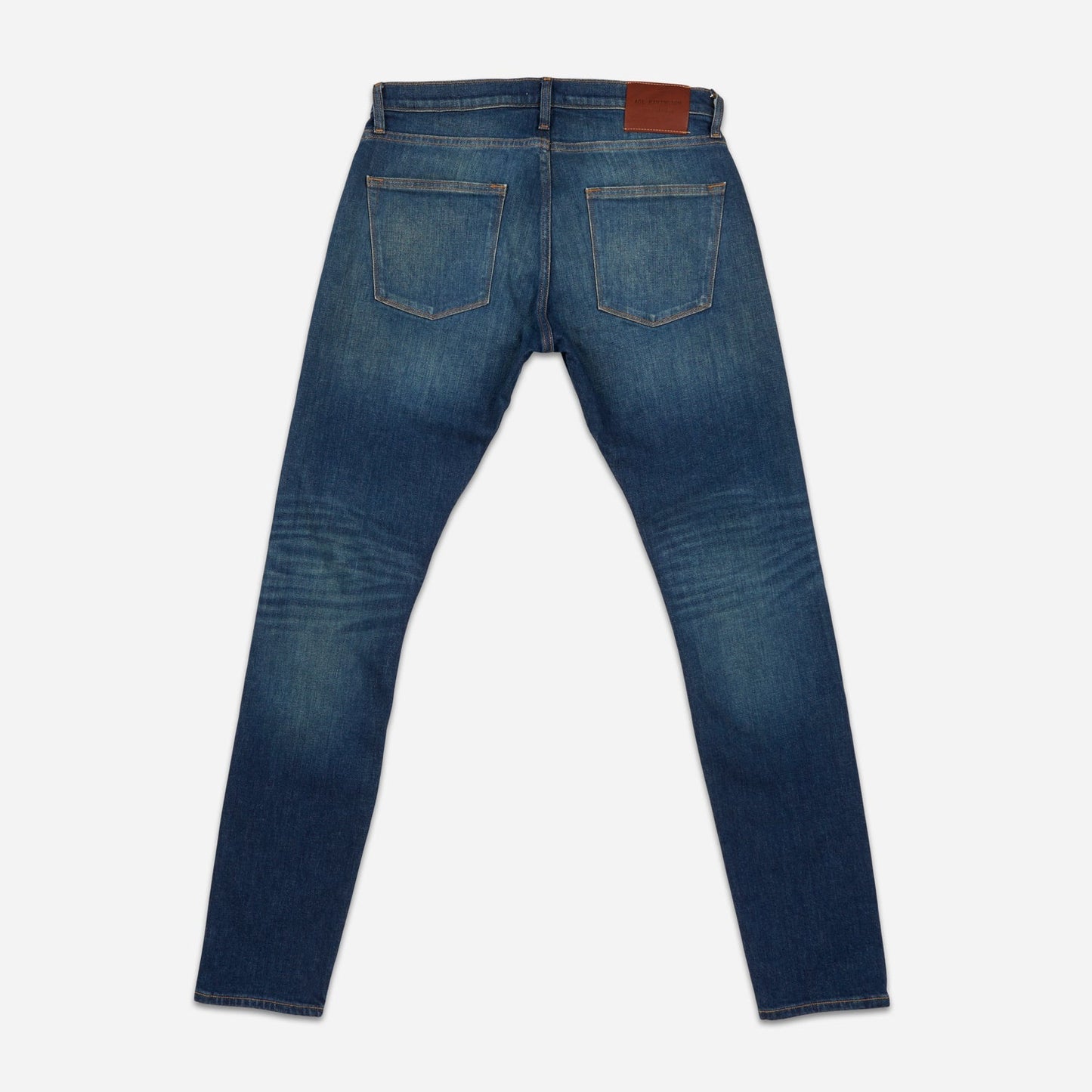 back of fully extended pair of high quality slim cut men's green hue blue jeans with slight wear