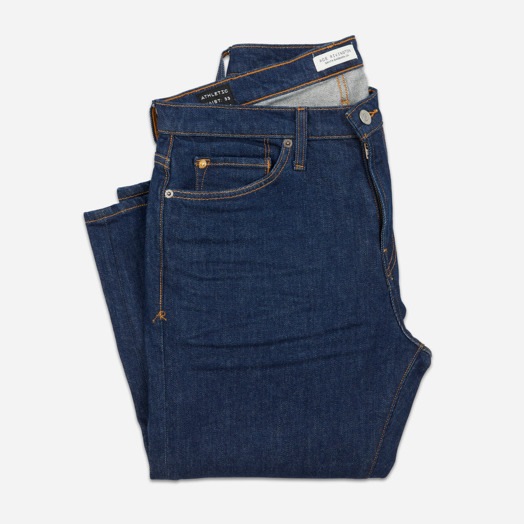 front of folded dark blue men's Ace Rivington athletic taper jeans with no wear